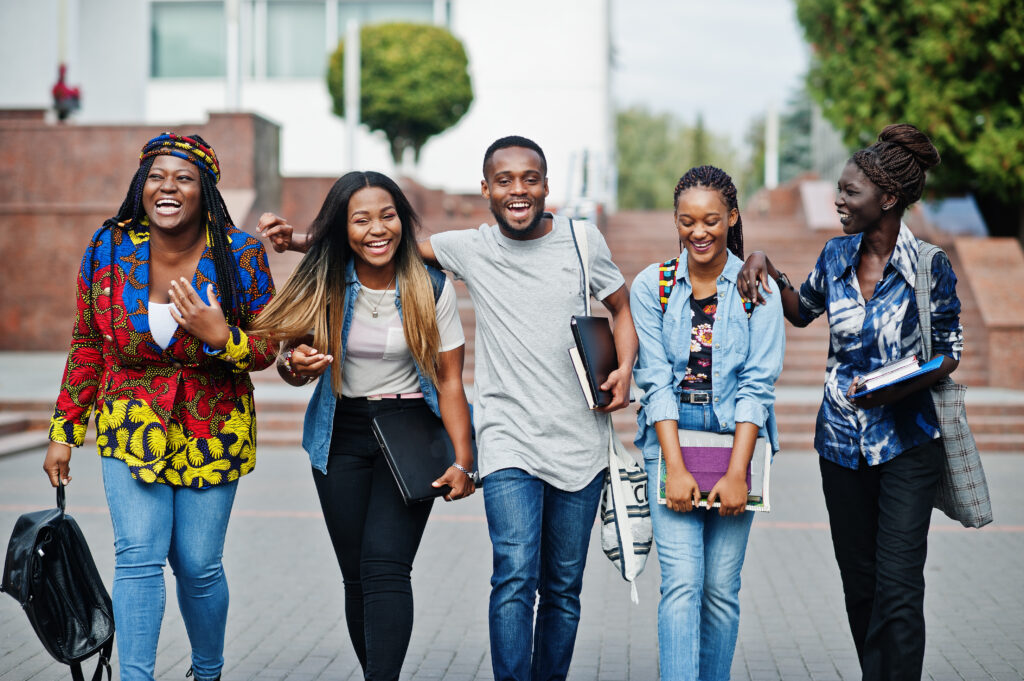 group of five african college students spending time together on