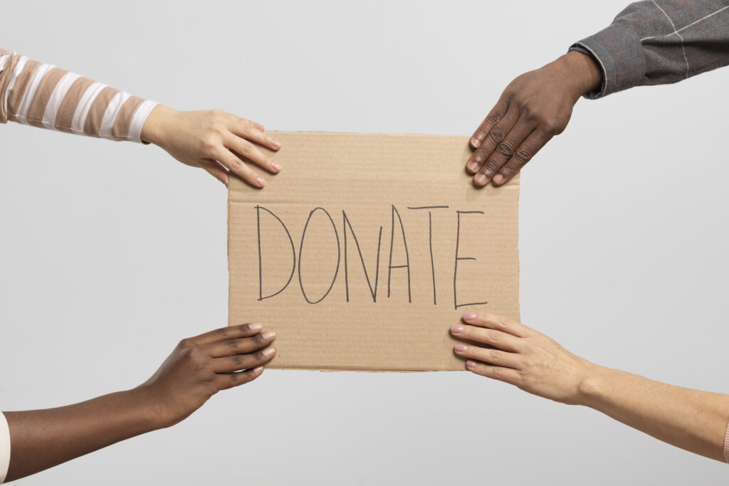 volunteers holding box containing donations charity